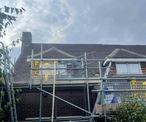 This is a photo of a roof with two dormers that is having some damaged tiles replaced. Works carried out by FCB Roofing Cranfield