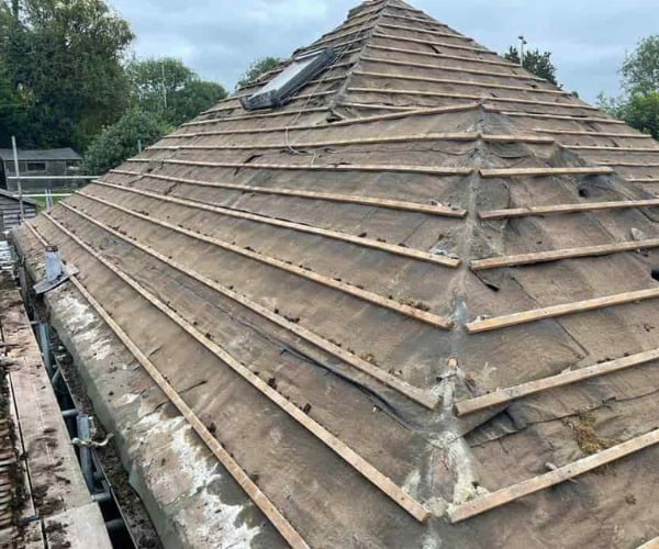 This is a photo of a hip roof that has been stripped back to the battens, and is awaiting a new roof covering to be installed. Works carried out by FCB Roofing Cranfield